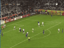 a soccer game is being played in front of a gillette and bud advertisement