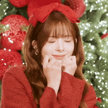 a girl wearing a red headband with a red bow on it