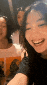 a group of young women are standing next to each other and smiling for the camera .