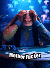 a man sitting at a table with cards and the words mother fucker