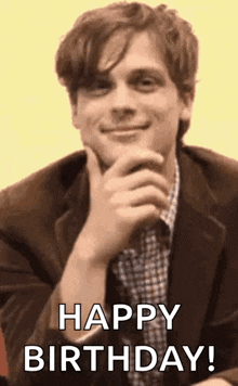 a man in a suit is smiling and holding his hand to his chin while saying happy birthday .