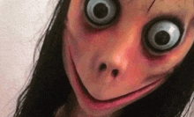 a close up of a woman 's face with big eyes and a scary smile