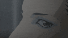 a close up of a woman 's face with a blue eye