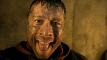 a man with a dirty face sticking out his tongue