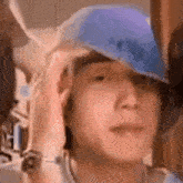 a man is wearing a blue hat on his head .
