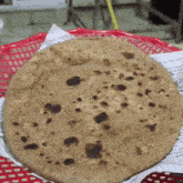 a tortilla in a red basket with a white napkin