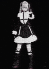 a black and white photo of a girl in a costume holding a gun .