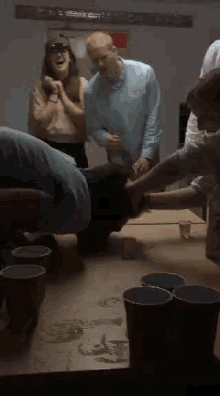 a group of people are playing a game of beer pong with red cups