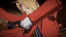 a man in a red jacket and white gloves