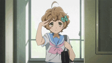 a girl in a sailor uniform salutes while holding a black bag