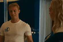 a man wearing a white shirt with the number 4 on it stands next to a woman
