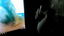 a person 's hand is visible in front of a computer screen that says ' windows ' on it