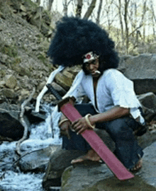 a man with a big afro is holding a sword
