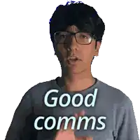 a man wearing glasses and a shirt that says good comms on it