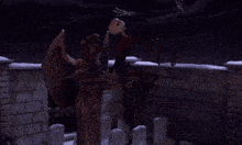 a statue of a skeleton with wings is holding a sword