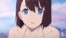 a close up of a girl with blue eyes and brown hair