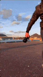 a man in a leather jacket is holding a camera in his hand