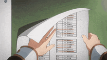 a person is holding a piece of paper that has a list of letters and numbers on it