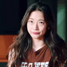 a young woman with long hair is wearing a shirt that says ' a wife ' on it