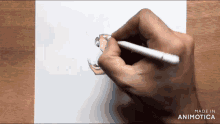 a person is drawing a cartoon character on a piece of paper with a made in animatica watermark