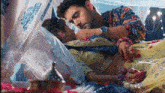 a man is putting his hand on a woman 's stomach while they are laying on a bed .