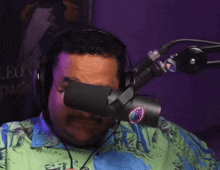 a man wearing headphones stands in front of a microphone with a poster in the background that says leg leopard on it