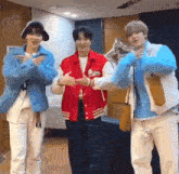 three young men are standing next to each other in a room and dancing .