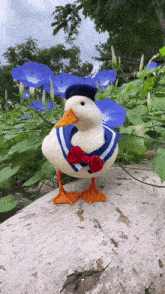 a stuffed duck wearing a sailor suit and hat