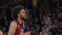 a basketball player with the number 22 on his jersey is pointing