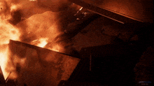 a dark room with a fire and the word dan allen on the bottom right