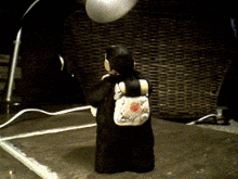 a figurine of a person with a backpack is standing on a table