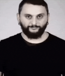 a man with a beard wearing a black shirt