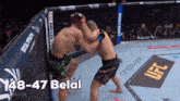 two men are fighting in a boxing ring with the words 48-47 belal written on the bottom
