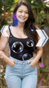 a woman in a black tank top and blue jeans is smiling with soap bubbles coming out of her chest