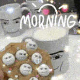 a cookie with smiley faces on it is on a table next to a cup of coffee and two mugs that say morning