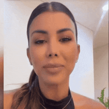 a close up of a woman 's face wearing a black top