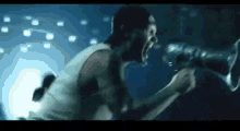 a man is screaming into a microphone in a dark room