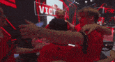 a group of people hugging in front of a sign that says ' victoria '