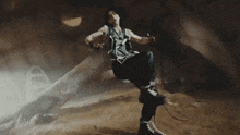 a man is standing in a cave with smoke coming out of the ceiling .