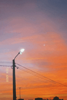 a street light is lit up in front of a sunset sky with the date of october 2nd