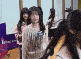 a girl stands in front of a sign that says mbc rad
