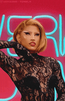 a woman in a black lace top is standing in front of a neon sign that says vonxodd tumblr