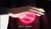 a person holding a red ball with the words hado 31 shakkano on it