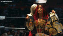 a woman in a wrestling ring is holding a belt that says ' wwe ' on it