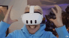 a man is wearing a virtual reality headset and smiling