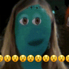 a woman with a green face is surrounded by a row of yellow smiley faces