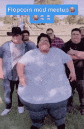 a group of men are posing for a picture and one of them has a flopcoin mod meetup sticker on his shirt