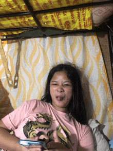 a woman in a pink shirt with a dragon on it