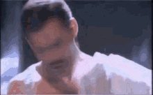 a close up of a man 's face with a mustache and a white shirt .