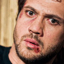 a man with a beard has a tear running down his eye